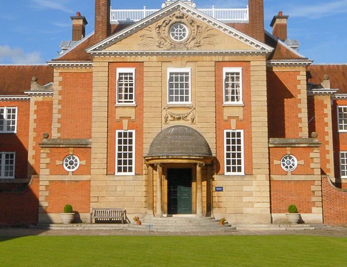 The red-brick main entrance and lawn of Lady Margaret Hall, Oxford