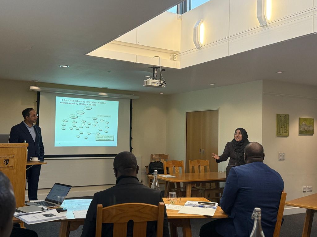 A speaker presenting to delegates in a seminar room