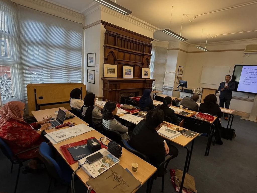 Delegates taking notes during a classroom session